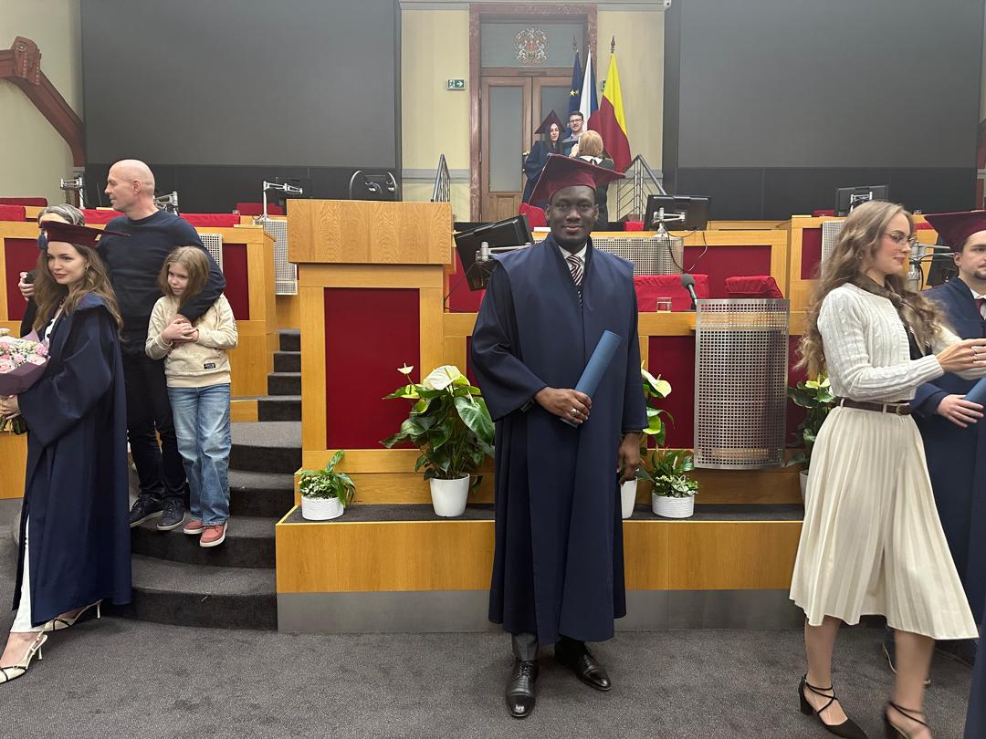 Fabian in graduation robes at a Czech university ceremony